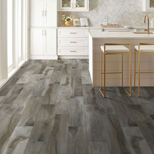 Contemporary kitchen with barstools and gray tile-look flooring.